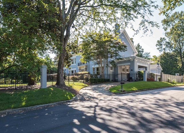 view of property hidden behind natural elements featuring a front yard