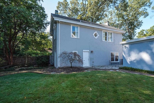 rear view of house with a lawn