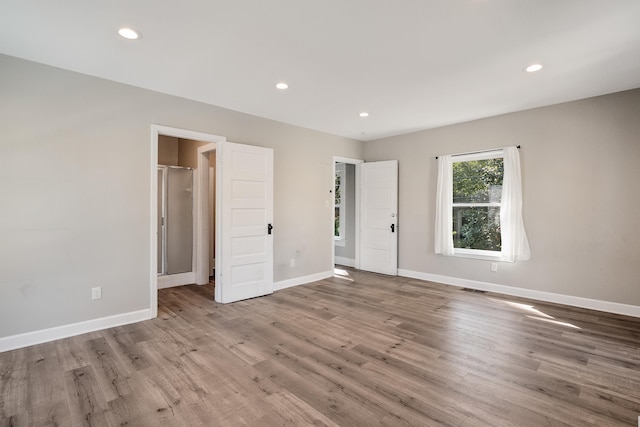 unfurnished room with wood-type flooring