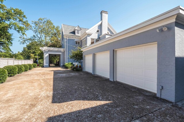 view of side of home with a garage