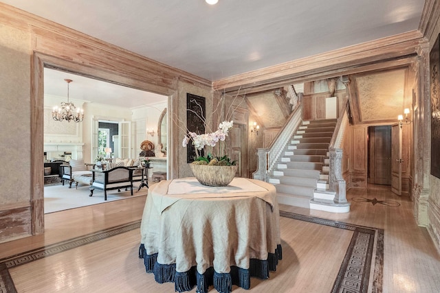 misc room with a chandelier, crown molding, and light wood-type flooring