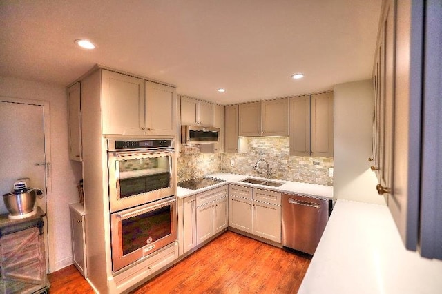 475 N Highland Ave Unit 3G, Memphis, TN 38122 - kitchen with tasteful backsplash, light hardwood / wood-style floors, stainless steel appliances, gray cabinets, and sink