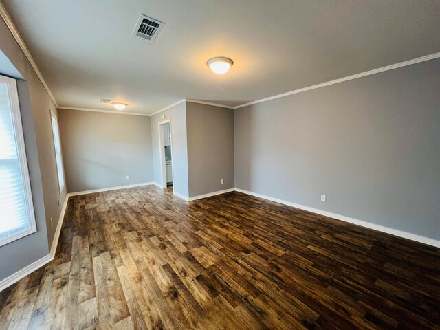 unfurnished room featuring dark hardwood / wood-style floors and ornamental molding