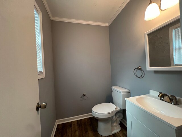 bathroom featuring oversized vanity, toilet, crown molding, and hardwood / wood-style flooring