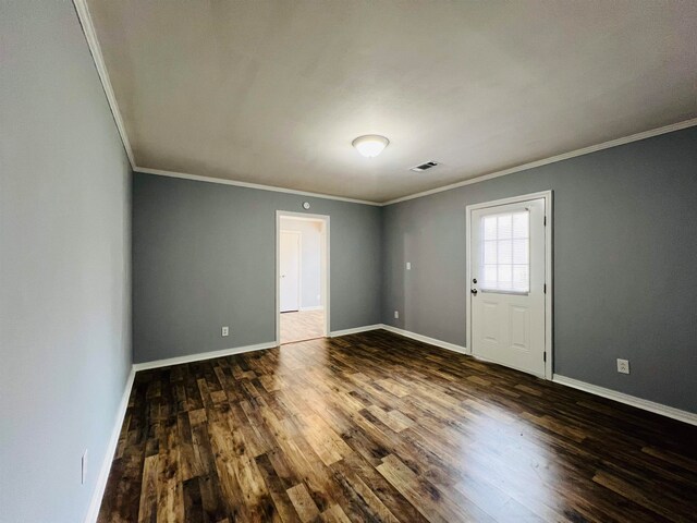 empty room featuring crown molding and hardwood / wood-style floors