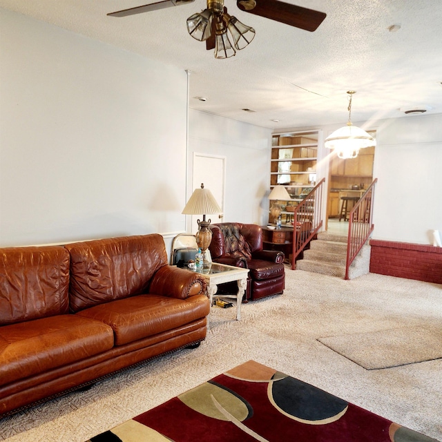 living room featuring light carpet, a textured ceiling, and ceiling fan with notable chandelier