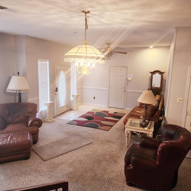 living room with light carpet, a textured ceiling, and ceiling fan with notable chandelier