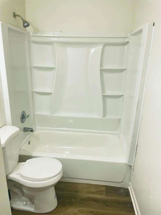 bathroom featuring toilet, wood-type flooring, and washtub / shower combination