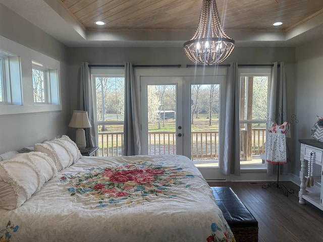 bedroom featuring a chandelier, wood ceiling, a raised ceiling, multiple windows, and dark hardwood / wood-style floors