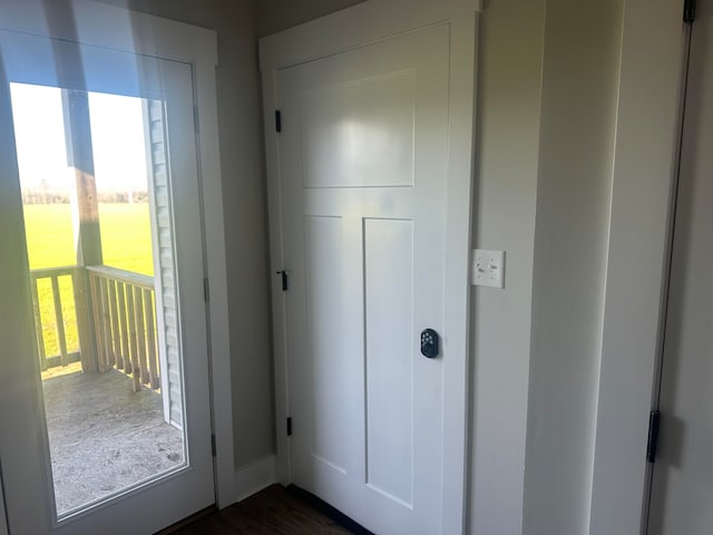 doorway with dark wood-type flooring