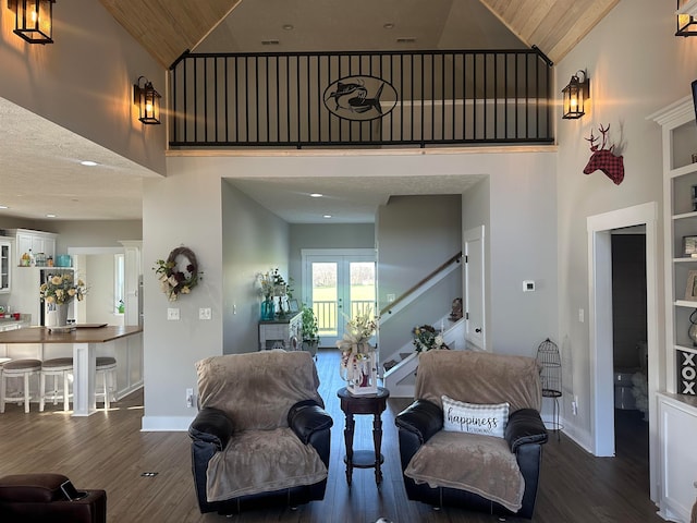 living room with high vaulted ceiling, dark wood-type flooring, and wood ceiling