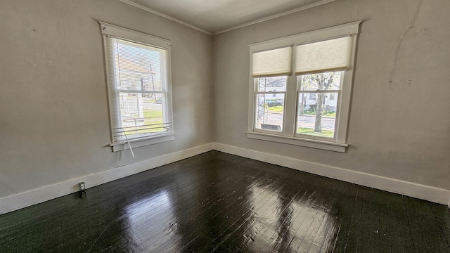 spare room featuring crown molding and dark hardwood / wood-style floors