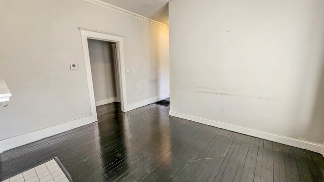 unfurnished room with crown molding and dark hardwood / wood-style flooring