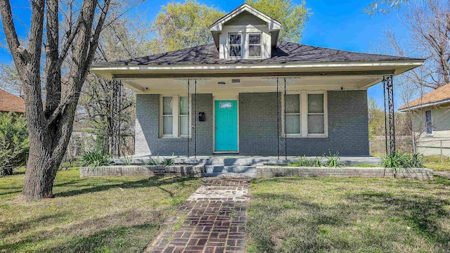 view of front of property with a porch and a front yard