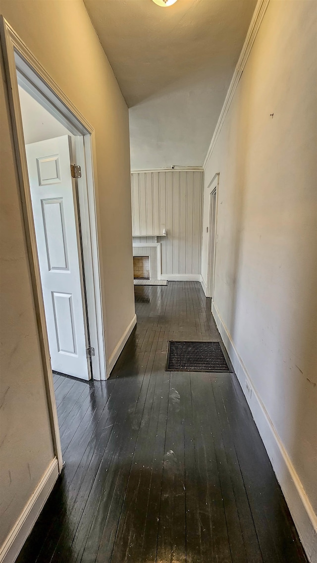 corridor with crown molding and dark hardwood / wood-style floors