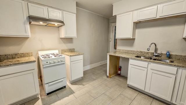 kitchen with white cabinets, sink, light stone counters, and white gas stove