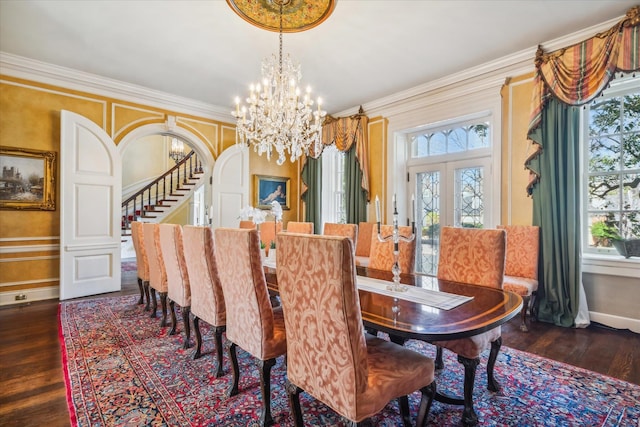 dining area featuring dark hardwood / wood-style floors, a notable chandelier, and a healthy amount of sunlight