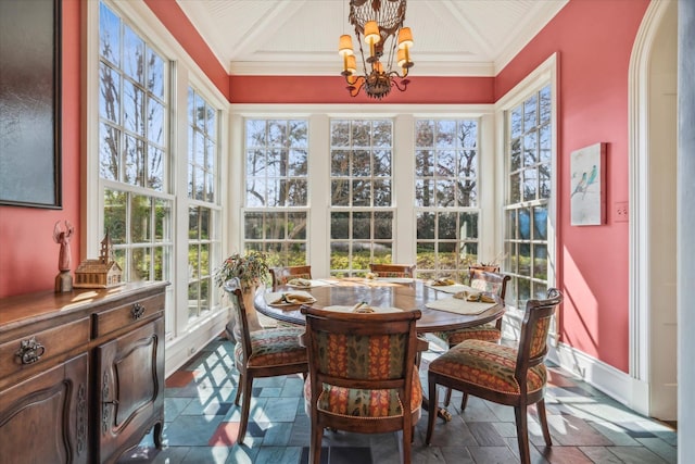 sunroom featuring coffered ceiling and an inviting chandelier