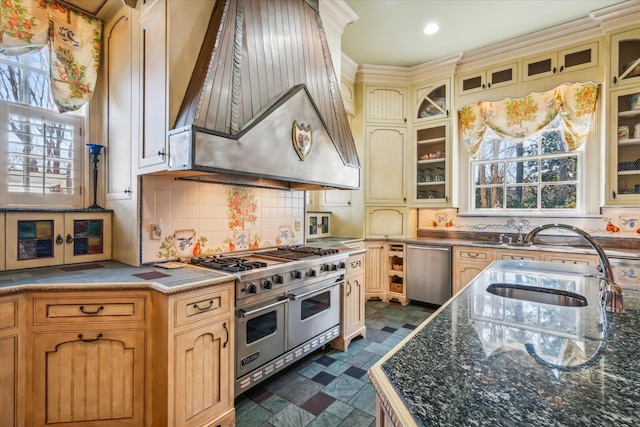 kitchen with sink, dark tile flooring, backsplash, double oven range, and premium range hood