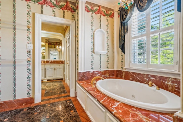 bathroom featuring a bath to relax in, tile floors, and vanity