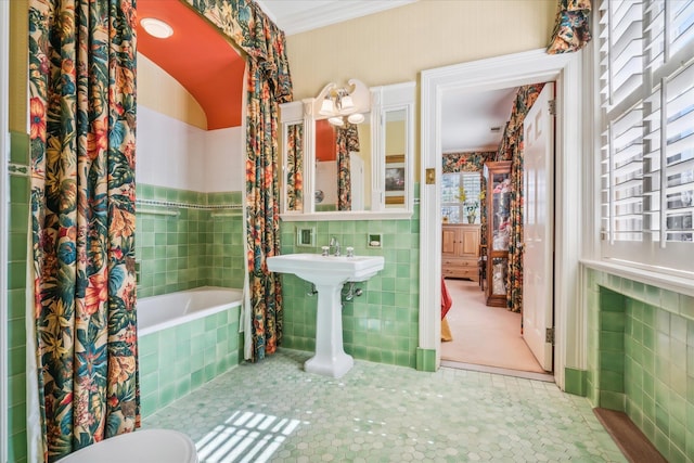 bathroom with tile flooring, toilet, and tile walls