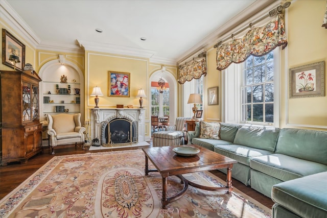 living room featuring ornamental molding, built in features, and dark hardwood / wood-style flooring