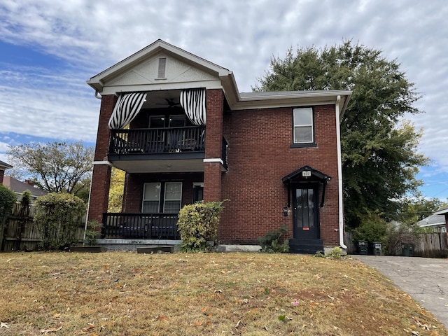 front of property with a front lawn and a balcony