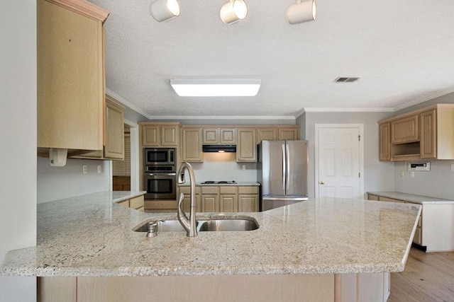 kitchen with light wood-type flooring, crown molding, stainless steel appliances, light stone counters, and range hood