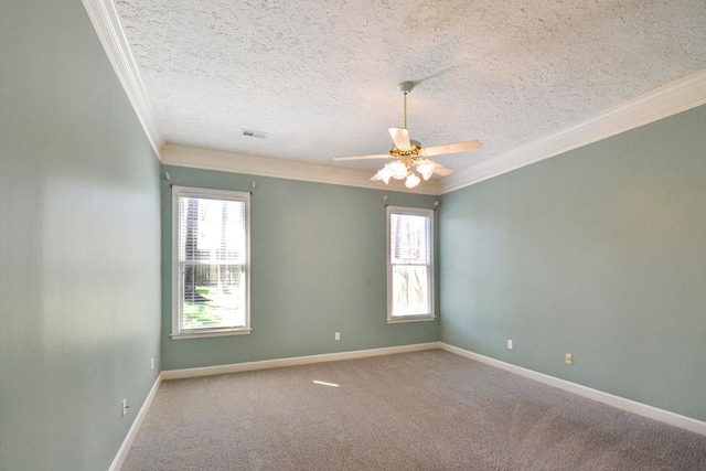 empty room featuring a wealth of natural light, a textured ceiling, ceiling fan, and carpet floors