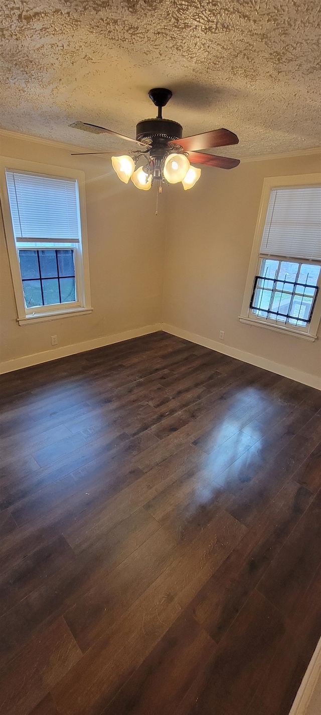 spare room with dark hardwood / wood-style floors, a textured ceiling, and ceiling fan