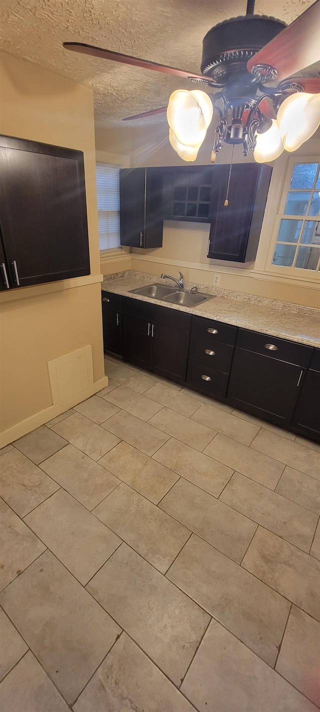 bathroom featuring tile floors, a textured ceiling, and sink