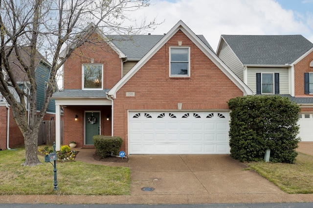 view of front of property featuring a front yard and a garage