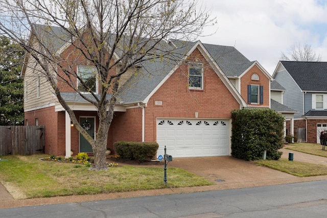 view of property featuring a front yard and a garage