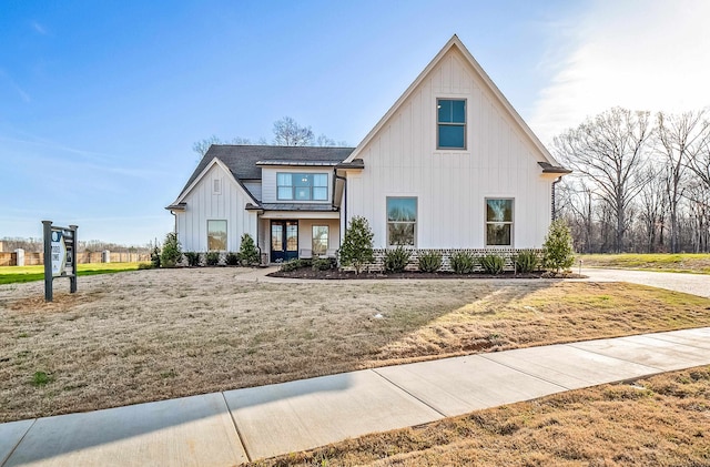 modern farmhouse style home featuring a front yard