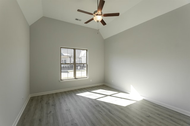 spare room with light wood-type flooring, lofted ceiling, and ceiling fan