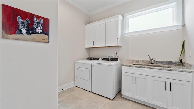 laundry area with cabinets, sink, light tile floors, crown molding, and washing machine and clothes dryer