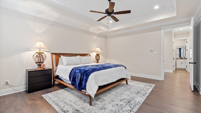 bedroom with a raised ceiling, ornamental molding, ceiling fan, and dark hardwood / wood-style floors