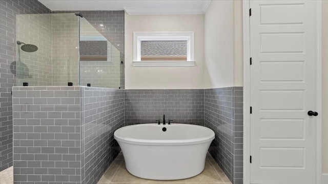 bathroom with tile walls, ornamental molding, plus walk in shower, and tile flooring