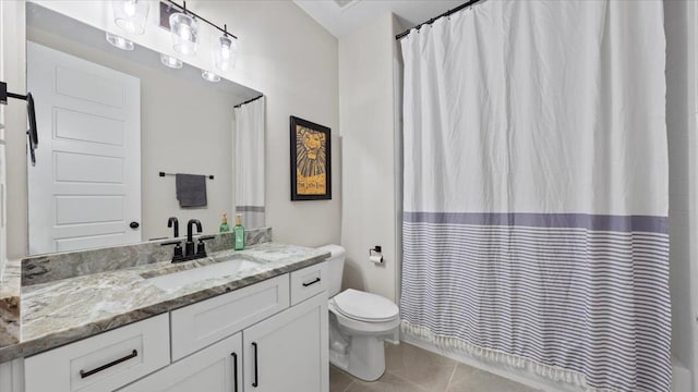 bathroom featuring toilet, tile floors, and oversized vanity