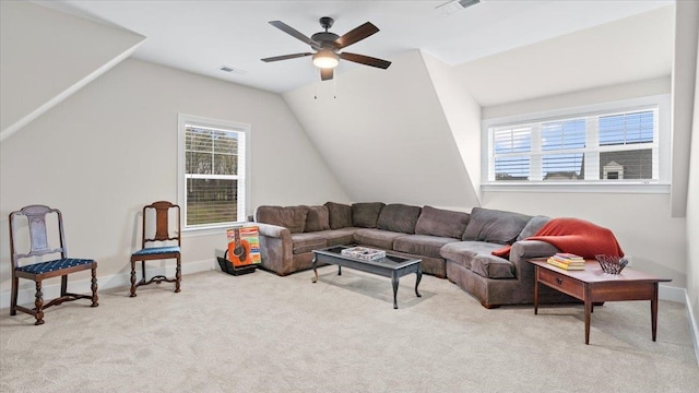 carpeted living room with plenty of natural light, ceiling fan, and vaulted ceiling