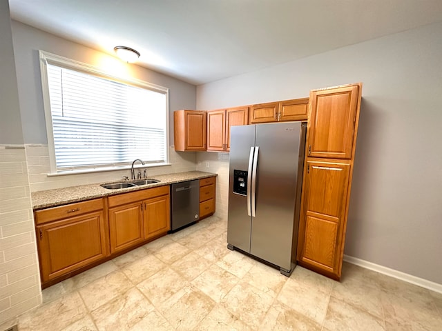 kitchen with sink, appliances with stainless steel finishes, light stone countertops, and light tile flooring