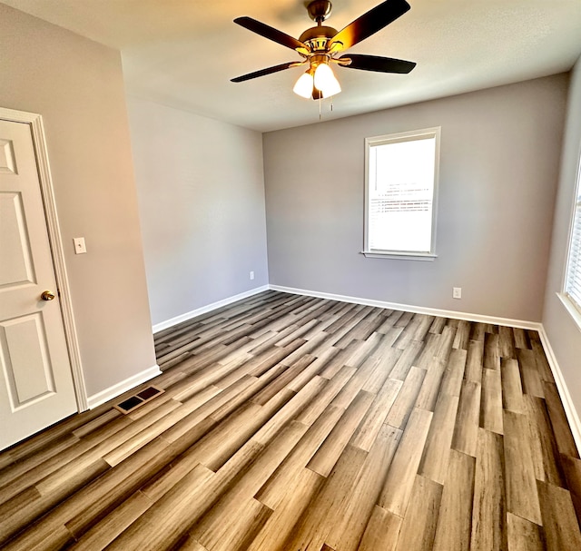 unfurnished room featuring light hardwood / wood-style flooring, ceiling fan, and a wealth of natural light