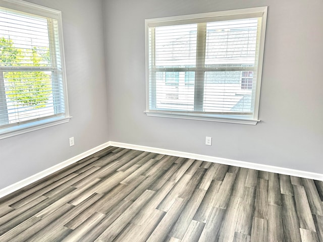 empty room with dark hardwood / wood-style flooring