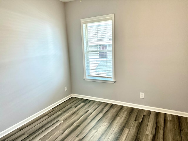 empty room with dark wood-type flooring