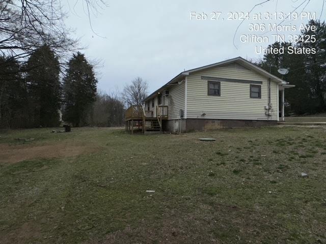 view of side of home featuring a lawn