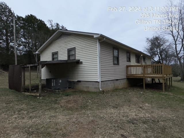 view of home's exterior with a wooden deck