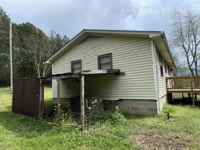 view of property exterior with a wooden deck