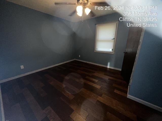 empty room with ceiling fan and dark hardwood / wood-style flooring