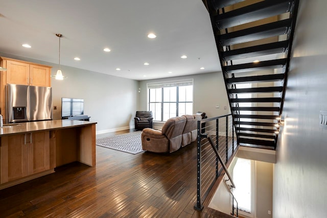 living room featuring sink and dark hardwood / wood-style flooring