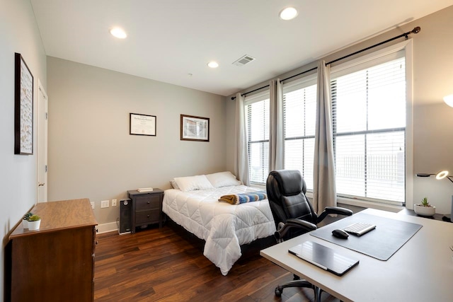 bedroom with dark hardwood / wood-style floors